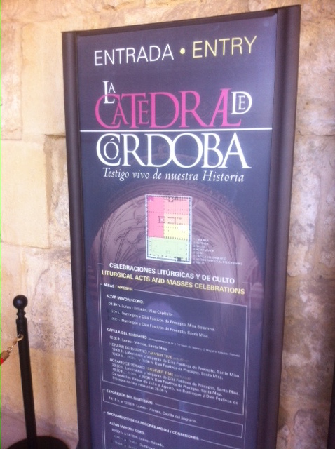 The covers of brochures about the Cordoba Mosque-Cathedral, published by the Church in 1981 and 1995, in contrast to the plaque welcoming visitors today