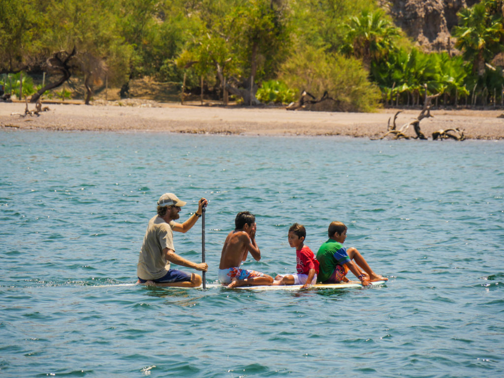 How many kids can you fit on a paddleboard? Josh and the kids test out this question.