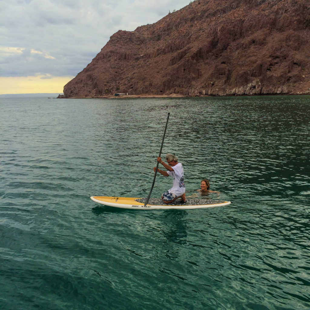 Steadying the paddleboard and showing Arnulfo how to use the paddle, Isla Espiritu Santo.