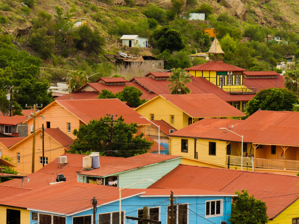 The red roofs and colorful clapboard sandwiched into the narrow arroyo of Santa Rosalía.