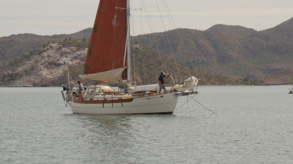 Jon and Shannon aboard Prism haul up the anchor in Guaymas harbor.