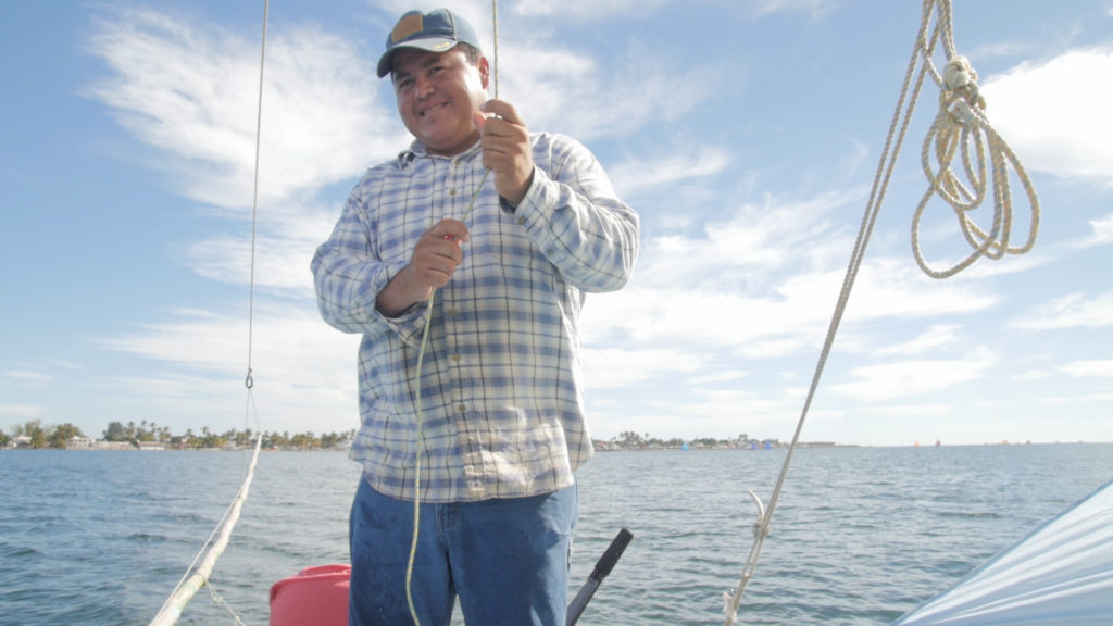 Alfonso adjusts the sail without looking. Photo from video by Jon Neely.