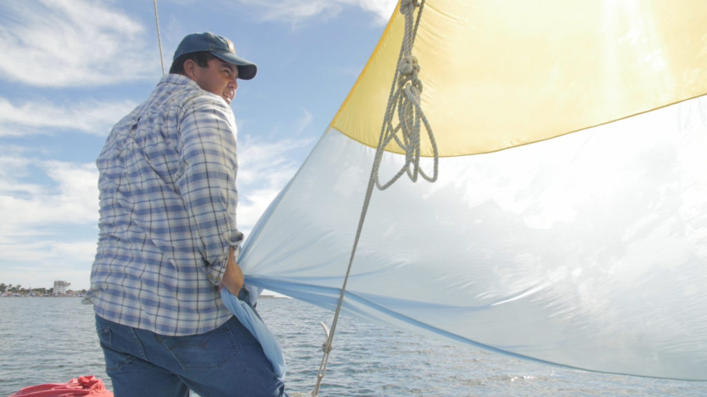 Adjusting the sails. Photo from video by Jon Neely.