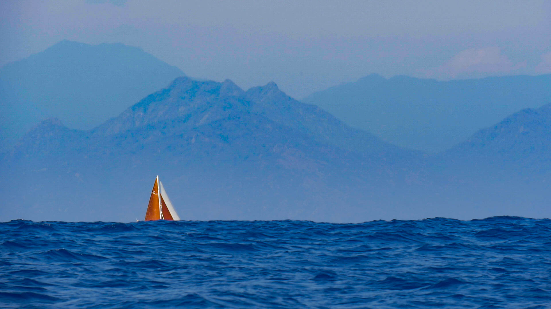 Sailing vessel Prism disappears beneath the swell in the Gulf of Tehuantepec.