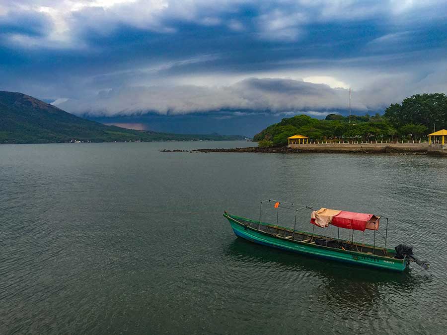  A long and colorful panga waits out the storm in front of town.