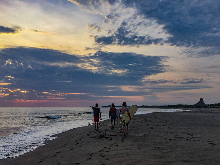 Surfers checking the break at sundown.