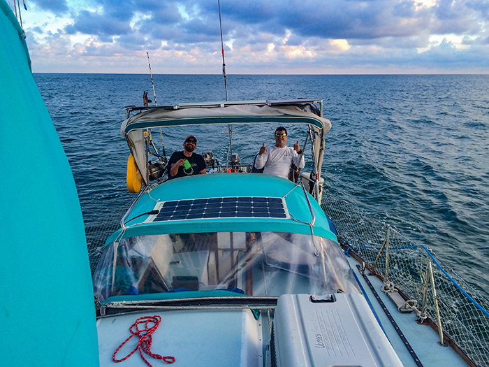 Under sail and moving with the swell, Oli still gives two thumbs up despite his queasiness.