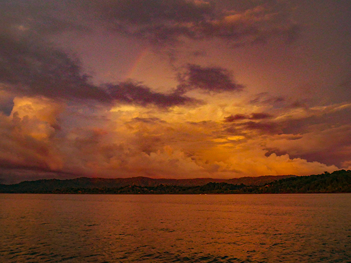 A storm builds at sunset, complete with a rainbow, at the edge of the Térraba watershed.