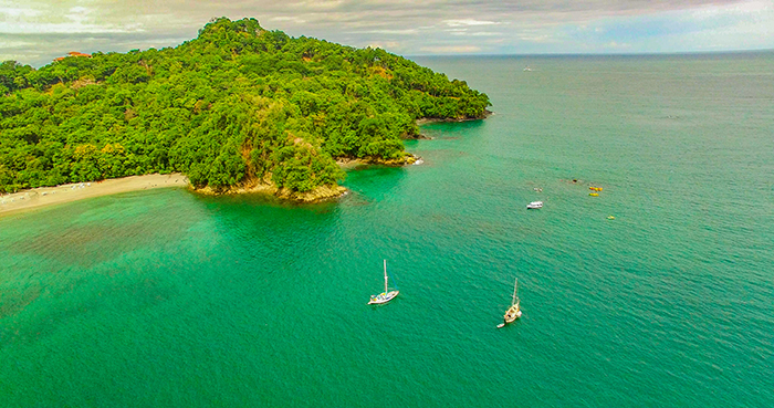 Oleada and Prism anchored in a cove popular with tourism boats near Quepos.