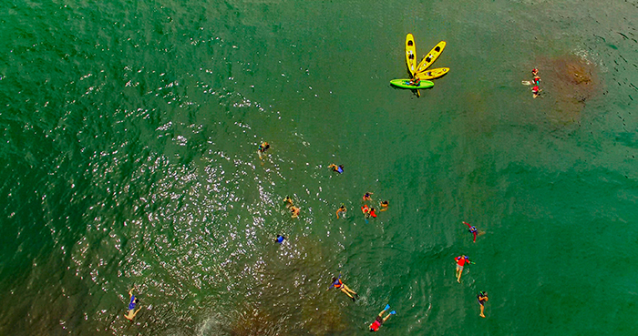 Tourists and kayaks in the water in Costa Rica.